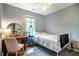 Comfortable bedroom featuring hardwood floors, a ceiling fan, and a desk at 121 Westview Dr # 22, Carrboro, NC 27510
