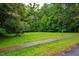 A lush green common area features picnic tables and walkways for residents to enjoy at 121 Westview Dr # 22, Carrboro, NC 27510
