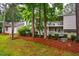 A beautiful two-story home features upper and lower balconies and mature trees at 121 Westview Dr # 22, Carrboro, NC 27510