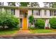 Charming townhouse with a wooden staircase leading to the entrance and lush landscaping at 121 Westview Dr # 22, Carrboro, NC 27510