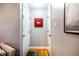 Inviting hallway with hardwood floors, a red mirror, and multiple doorways at 121 Westview Dr # 22, Carrboro, NC 27510