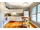 Bright kitchen featuring white cabinets, wood floors, granite countertops, and large window with natural light at 121 Westview Dr # 22, Carrboro, NC 27510
