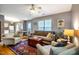 Spacious living room featuring a cozy sofa, chairs, and an area rug, with dining area in view at 121 Westview Dr # 22, Carrboro, NC 27510