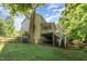 Home backyard featuring green grass, a wooden fence, and a house with a deck at 122 N Fern Abbey Ln, Cary, NC 27518