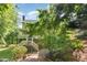 The home features a cozy backyard with brick pavers and stairs up to a covered back deck at 122 N Fern Abbey Ln, Cary, NC 27518