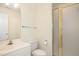 Clean, well-maintained bathroom featuring white fixtures, a shower with frosted doors at 122 N Fern Abbey Ln, Cary, NC 27518