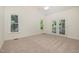 A bedroom with carpet, vaulted ceiling, ceiling fan, and patio access at 122 N Fern Abbey Ln, Cary, NC 27518