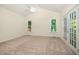 A bedroom with carpet, vaulted ceiling, ceiling fan, and patio access at 122 N Fern Abbey Ln, Cary, NC 27518