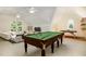 Large bonus room with a pool table, ping pong, and comfortable seating, creating a versatile entertainment space at 122 N Fern Abbey Ln, Cary, NC 27518