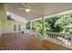 Inviting covered deck with a ceiling fan and wood flooring, perfect for outdoor relaxation and entertaining at 122 N Fern Abbey Ln, Cary, NC 27518