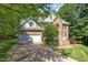 Attractive two-story home featuring a brick facade, well-kept landscaping, and a spacious driveway, offering curb appeal at 122 N Fern Abbey Ln, Cary, NC 27518
