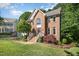 Charming two-story brick home with manicured landscaping, a welcoming entrance, and a well-maintained front yard at 122 N Fern Abbey Ln, Cary, NC 27518