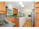 Spacious kitchen with wooden cabinets, granite countertops, and stainless steel appliances at 122 N Fern Abbey Ln, Cary, NC 27518