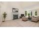 Inviting living room featuring a fireplace, plush seating, and abundant natural light at 122 N Fern Abbey Ln, Cary, NC 27518