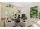 Bright living room with high ceilings, fireplace, and large windows offering serene views at 122 N Fern Abbey Ln, Cary, NC 27518