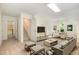Bright and open living room with a TV, comfortable seating, and workspace, perfect for relaxing and productivity at 122 N Fern Abbey Ln, Cary, NC 27518