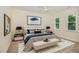 Comfortable bedroom with a ceiling fan, large windows, and elegant decor, creating a cozy and inviting atmosphere at 122 N Fern Abbey Ln, Cary, NC 27518