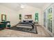 Serene primary bedroom with large windows and French doors leading to a private balcony at 122 N Fern Abbey Ln, Cary, NC 27518
