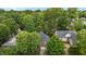 An aerial view shows this home nestled amongst mature trees in a lovely neighborhood at 1224 Wedgeland Dr, Raleigh, NC 27615