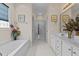 Relaxing primary bathroom with white tile, a garden tub, and a glass shower at 1224 Wedgeland Dr, Raleigh, NC 27615