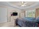 Bright bedroom with a tray ceiling, ceiling fan, and a view of the backyard at 1224 Wedgeland Dr, Raleigh, NC 27615