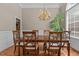 Inviting dining room with a chandelier, seating for six, and natural light at 1224 Wedgeland Dr, Raleigh, NC 27615