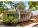 Back of house with new deck, great natural light, and mature landscaping at 1224 Wedgeland Dr, Raleigh, NC 27615