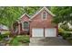 Beautiful brick home featuring an attached two-car garage and well-maintained landscaping at 1224 Wedgeland Dr, Raleigh, NC 27615