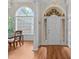 Bright foyer with hardwood floors, large windows, and a view of the dining area at 1224 Wedgeland Dr, Raleigh, NC 27615