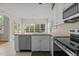 Modern kitchen with stainless steel appliances and white cabinets offers a bright space at 1224 Wedgeland Dr, Raleigh, NC 27615