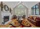 Cozy living room with a fireplace, comfortable seating, and a large window at 1224 Wedgeland Dr, Raleigh, NC 27615