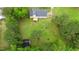 Expansive backyard featuring a large lawn and mature trees, complete with a detached shed and rear deck at 124 Windmere Dr, Angier, NC 27501