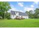 Two-story home featuring a spacious green yard and wooden deck at 124 Windmere Dr, Angier, NC 27501