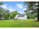 Exterior view of a two-story home with a large yard and wooden deck at 124 Windmere Dr, Angier, NC 27501