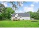View of a two-story home with a deck and spacious backyard at 124 Windmere Dr, Angier, NC 27501