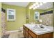 Bathroom featuring double sinks, a large mirror, and a shower/tub combo at 124 Windmere Dr, Angier, NC 27501