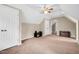 Spacious carpeted room with a ceiling fan, closet, and a door at 124 Windmere Dr, Angier, NC 27501