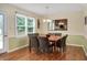 Charming dining area with a wooden table and woven chairs, illuminated by a modern chandelier at 124 Windmere Dr, Angier, NC 27501