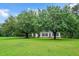 Traditional home with a large front yard and mature trees creating a serene setting at 124 Windmere Dr, Angier, NC 27501