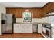 Eat-in kitchen features stainless appliances, solid surface countertops, and white cabinetry at 124 Windmere Dr, Angier, NC 27501