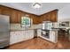 Traditional kitchen features stainless steel appliances, white cabinets, and hardwood flooring at 124 Windmere Dr, Angier, NC 27501