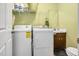Well-lit laundry room with shelving, a washer, and a dryer at 124 Windmere Dr, Angier, NC 27501