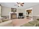 Cozy living room featuring a brick fireplace, with neutral tones and a doorway leading to the kitchen at 124 Windmere Dr, Angier, NC 27501