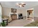 Comfortable living room featuring a fireplace, with neutral tones and a doorway leading to the kitchen at 124 Windmere Dr, Angier, NC 27501