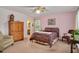 Bedroom features a ceiling fan, a window, and an ensuite bath at 124 Windmere Dr, Angier, NC 27501