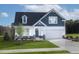 Charming two-story home with blue and white siding, a well-manicured lawn, and an attached two car garage at 135 Harmony Ranch Lane, Franklinton, NC 27525