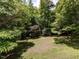 Backyard with mature trees and an open grassy area at 1514 John Jones Rd, Bahama, NC 27503