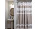 Cozy bathroom featuring a pedestal sink and a striped shower curtain at 1514 John Jones Rd, Bahama, NC 27503