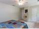Neutral bedroom with a patterned bedspread, dresser, and ample closet space at 1514 John Jones Rd, Bahama, NC 27503