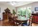 Traditional dining room with wood floors, a large table, and a window offering natural light and greenery at 1514 John Jones Rd, Bahama, NC 27503